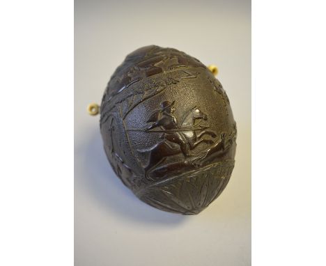 An Early 19th Century Carved Coconut Bugbear Powder Flask, The Body Carved in Relief with various Hunting Scenes and Mask Top