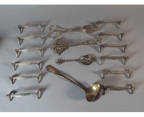 A Collection of Silver Plate to Include 12 Knife Rests, 2 Cake Servers, Dutch Windmill Spoon and A Plated Sauce Ladle