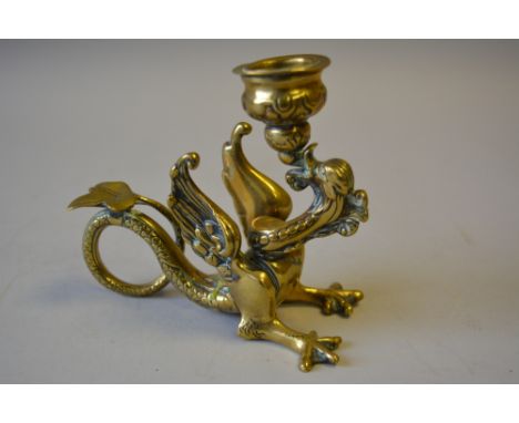 A Decorated Brass Novelty Candlestick in the Form of a Dragon with Coiled Trail. 11.5cm Long. 