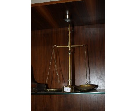A BRASS SET OF SCALES AND WEIGHTS (1 MISSING)
