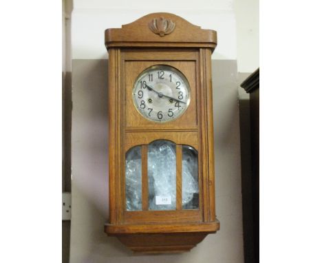 AN EDWARDIAN OAK CASED MANTEL CLOCK