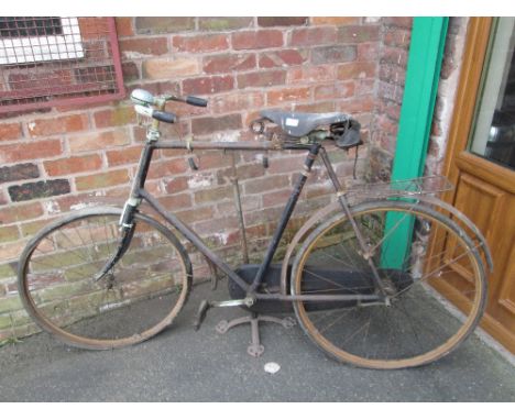 A VINTAGE BICYCLE ON A CAST HUTTON AND CO STAND