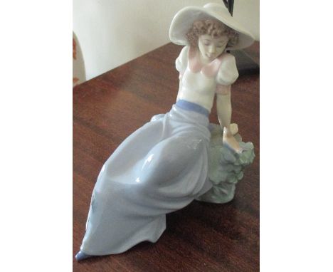 A Nao Figure of a Girl and a Bird.