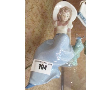 A Nao Figure of a Seated Girl & Bird Beside.