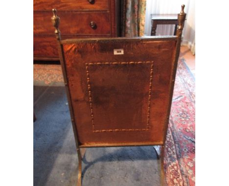 An Early 20th Century Firescreen having embossed copper panel.