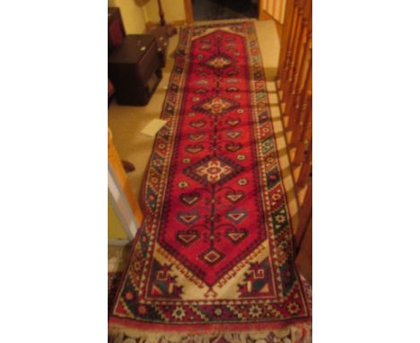 A Turkish 100% Wool Red Ground Runner approximately 9'6" long by 2'6" wide.