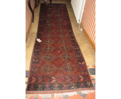An Afghan Wool Runner with brick red ground and geometric detail within narrow running borders. 10ft x 32ins.