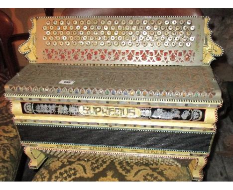 A Large Good Quality Accordion with extensive inlaid decoration to the simulated mother of pearl casing, with further mother 