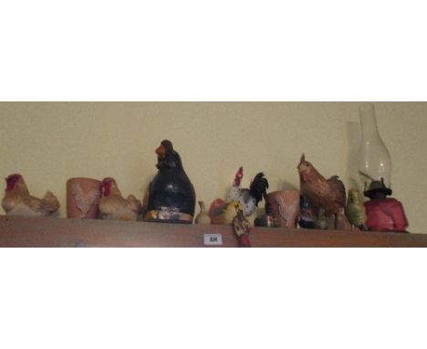 An Oil Lamp with Ruby Glass Base, along with a quantity of figural hens & chickens (above door leading to conservatory).