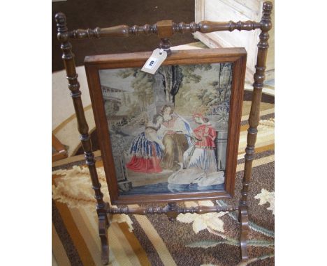A Needlework Firescreen in Turned Frame, the needlework panel depicting ladies feeding swans. 31 1/2in tall.