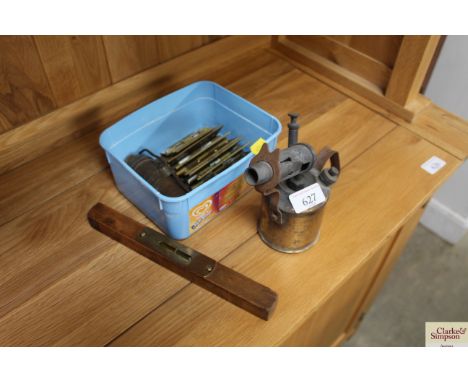 A blow lamp, spirit level, and a box of door hinges etc.