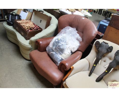 A leather upholstered and button back arm chair