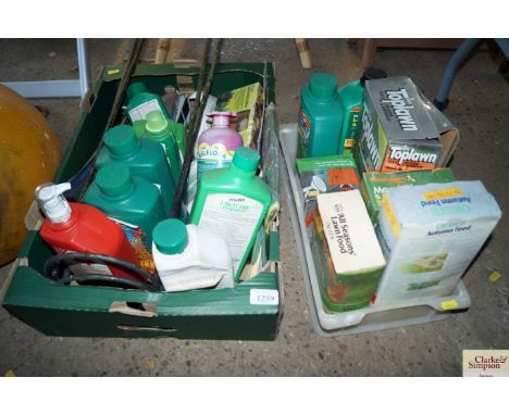 Two boxes containing various gardening items to include plant and lawn feed; metal stakes; hand tools etc