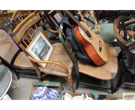A green painted rush seated ladder back chair and a cane elbow chair