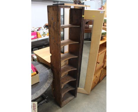 A stained pine open shelf unit