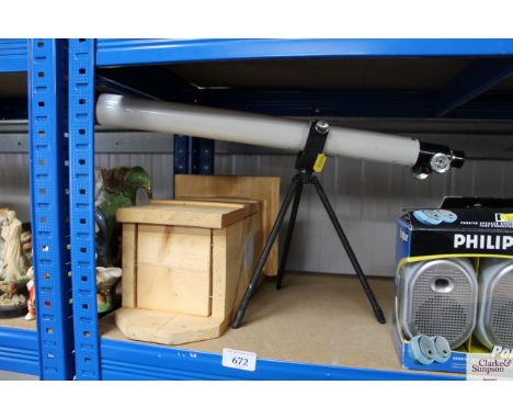 A telescope and a wooden bird box 