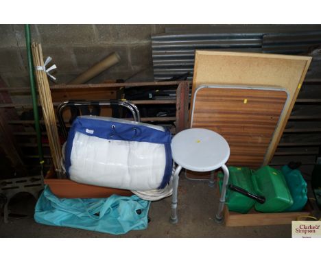 A large quantity of various household and other items to include plastic fuel cans; folding table; cork board; a disability s