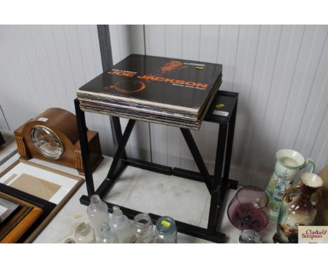 Two speaker stands and a collection of records