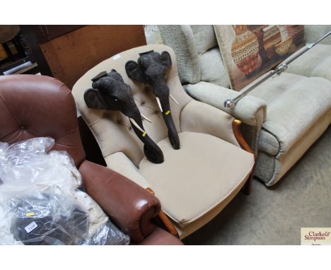A wooden framed and button back arm chair