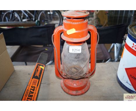 A metal and glass hurricane lamp 
