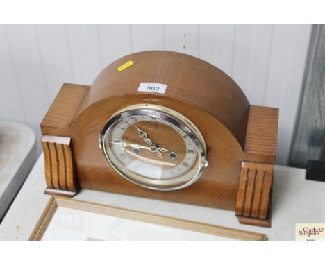 An oak cased two hole mantel clock