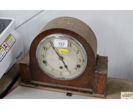 An oak cased three hole mantel clock