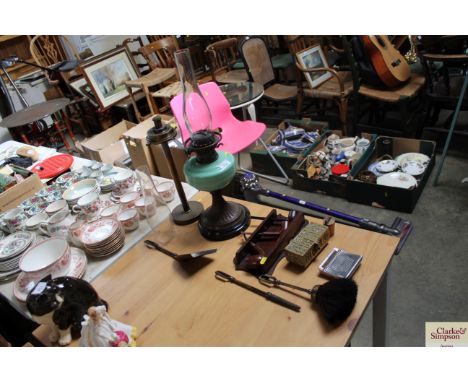 A companion set, brass based oil lamp, brass trinket box, pipe rack and three pipes etc.