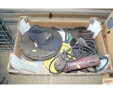 A Sealey hand held electric grinder; and a quantity of various grinding discs
