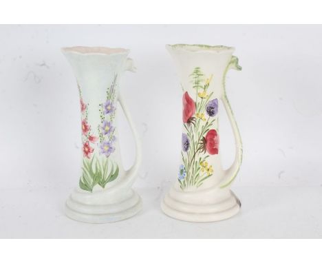 Pair of Elizabeth Radford vases, each of slender form, with painted flowers and swan neck handles, 25.5cm tall (2)