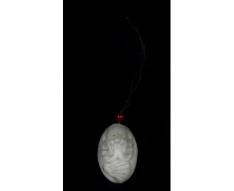 An early 20th century Chinese carved pebble jade amulet of a mandarin with a fan, H. 6cm (some wear to beard and face).