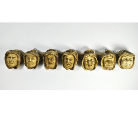An unusual 19th century wall mounted "chalk" pipe holder, W. 50cm.