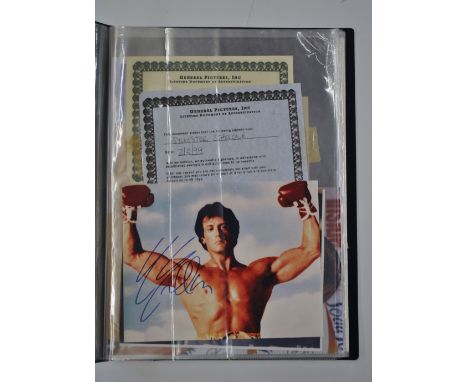 A folio of autographed photographs including Sylvester Stallone, Celine Dion, Van Morrison etc.