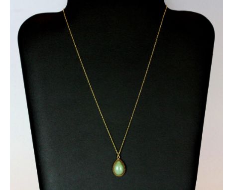 A 9ct gold and jade pendant and chain, H. 1.5cm (jade size).