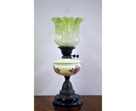 A Victorian painted opaline glass and brass oil lamp with a green fluted shade, H. 59 cm.