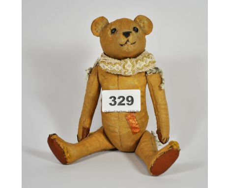 An unusual articulated ceramic teddy bear, H. 20cm.