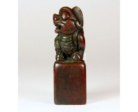 A Chinese carved red soapstone seal, H. 7.5cm.