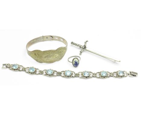A silver and blue stone bracelet, a silver dagger brooch, a silver child's bangle and a sterling silver Delft ring, 48.5g