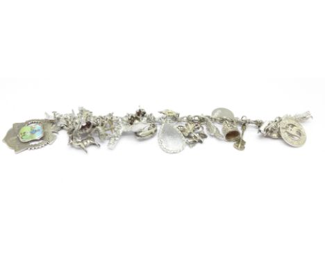 A silver and white metal charm bracelet with a silver and enamel football fob, enamel a/f