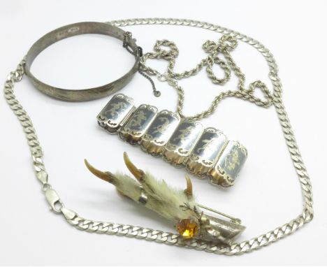 Two silver necklaces, a silver bangle, a silver bracelet and a Scottish silver claw brooch