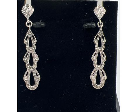 A boxed pair of Art Nouveau style silver drop earrings set with marcasite stones. Total drop approx. 5cm. Silver marks to bac