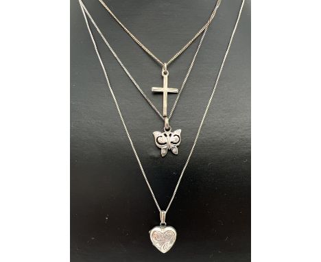 3 silver pendants necklaces. A 19" box chain with floral engraved small heart locket; an 18" curb chain with butterfly pendan