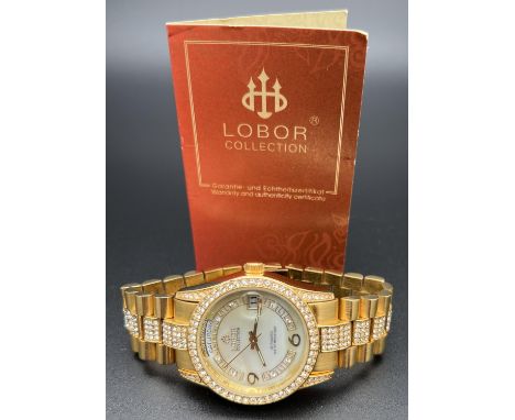 A ladies modern automatic wristwatch by Lobor Collection. Gold tone stainless steel strap and case set with clear crystals. M