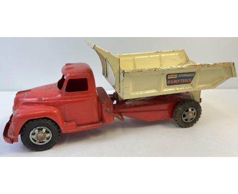 A vintage 1950's tinplate Buddy L Hydraulic Dump Truck, by Mettoy. Painted red cabin and base with cream painted dump back. D