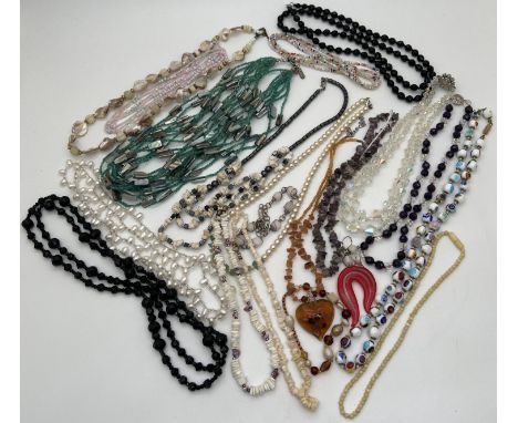 A collection of vintage and modern, natural stone, pearl, glass bead and shell necklaces. To include aurora borealis, amethys