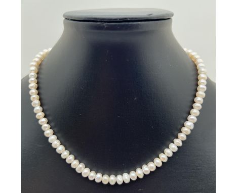 A 16" freshwater pearl necklace with silver tone T bar clasp. Pearls approx. 6.5mm width. Retired jewellery makers stock. 