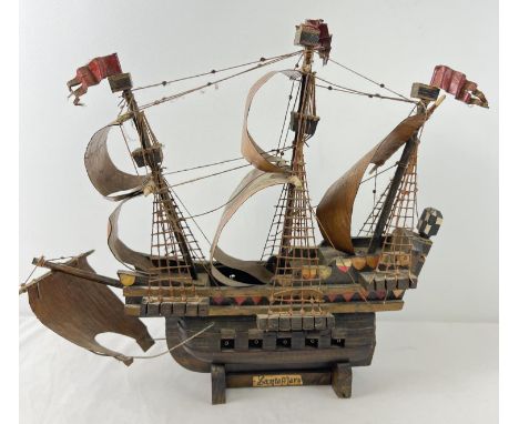 A wooden hand made model of the Santa Maria Spanish Galleon. Hand painted detail to all sails. Approx. 40cm x 43cm. 