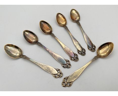 A set of 6 continental silver gilt coffee spoons, each stamped to reverse of handle '830S &amp; NM'. With decorative foliate 