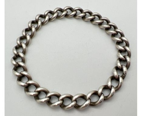 A vintage silver 7" fixed curb chain bracelet, each link stamped with lion passant. Chain width 8mm, total weight approx. 33.