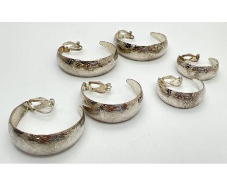 3 pairs of vintage, graduating, white metal, clip on half hoop earrings with floral pattern. Largest approx. 4cm diameter. 