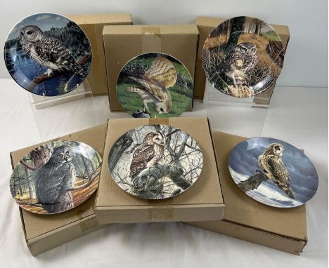 A boxed set of 12 Wedgwood ceramic collectors plates from the series "The Majesty of Owls". By Trevor Boyer for Danbury Mint,